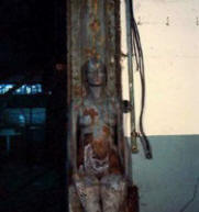 Woman in front of front of corroded hanger