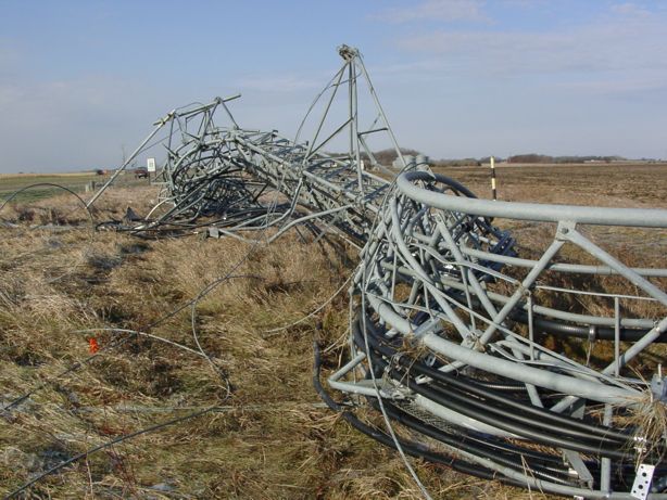 Mangled communication tower fallen due to loss of the anchor 