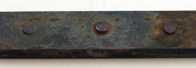 Copper rivets on a steel bar submerged in 3% sodium chloride solution after ten months