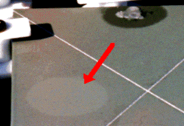 Faded spot that developed on the surface of coated sample at location of portable EIS cell. The cell was attached, filled with electrolyte, and removed several months before photo was taken.